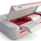 A photo of the Evercade VS retro game console with its front-loading cartridge slot open.
